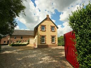 a brick house with a red fence in front of it at Wijlre Farmhouse stay in Wijlre