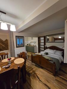 a bedroom with a large bed and a table and chairs at Noclegi Panorama in Ustrzyki Dolne