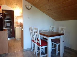 einen Esstisch und Stühle in der Küche in der Unterkunft Bungalow in Kolczewo with parking space in Kołczewo + 54 Fotos