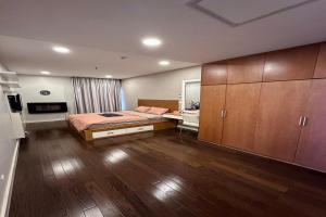 a bedroom with a bed and a desk and cabinets at Lancaster Hanoi City Center Apartments in Hanoi +37 photos