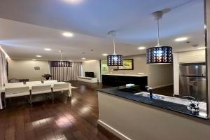 a kitchen and living room with a kitchen and a living room at Lancaster Hanoi City Center Apartments in Hanoi