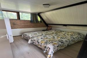 a bedroom with a bed in a room at Dine & Unwind Vacation Spot in Stramproy