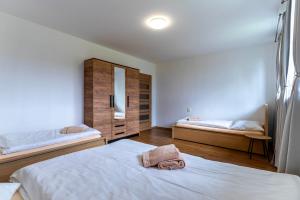 a bedroom with two beds and a bag on the bed at Apartmán BUĎA in Červená Voda