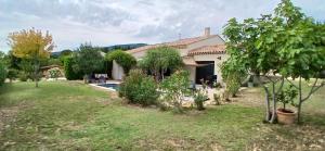 a house with a garden and a swimming pool at Villa de charme à Cucuron au pied du luberon in Cucuron