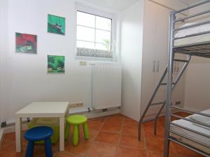 a room with a table and two chairs and a bunk bed at Apartment, Trassenheide in Trassenheide