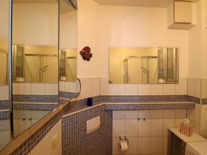 a bathroom with mirrors and a sink and a toilet at Apartment, Trassenheide in Trassenheide +16 photos
