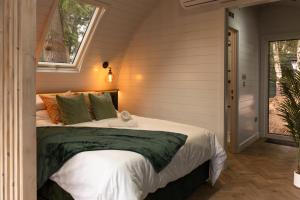 a bedroom with a large bed with a window at AvantGlamp in Marston Green