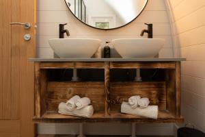 a bathroom with two sinks and a mirror at AvantGlamp in Marston Green +55 photos