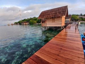 a house on a dock on a body of water at ParfrayHomestay Raja ampat in Besir