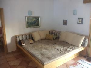 a living room with a couch in the corner at Chalet in Niederndorf near Kufstein with balcony in Niederndorferberg