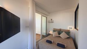 a bedroom with a bed with a large window at Magnifique vue mer et terrasse Garage Clim WiFi - ROSSIconciergerie - Linge inclus in La Grande-Motte
