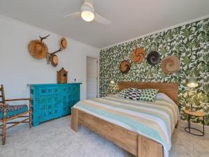 a bedroom with a bed and a wall with hats at Elegant Villa with Pool in Benissa