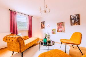 a living room with orange furniture and a window at Villa Klosterschenke Sauna Whirlpool Game Room in Sankt Goarshausen +62 photos