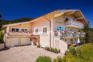 a large house with balconies and a yard at Haus Bella Vista in Reit im Winkl