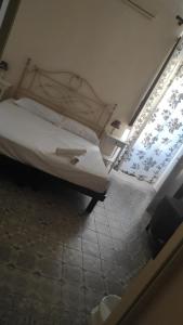 a bedroom with a bed and a window at Albergo Bernini in Siena +8 photos