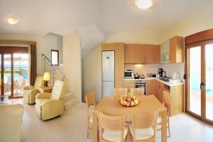 a kitchen and living room with a table and chairs at Holiday home in Kiotari near the beach in Kiotari