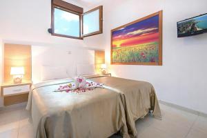 a bedroom with a large bed with flowers on it at Holiday home in Kiotari near the beach in Kiotari +78 photos