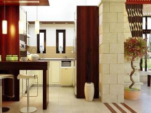 a kitchen with a counter and a table in it at Villa in Platanias with a private pool in Plataniás