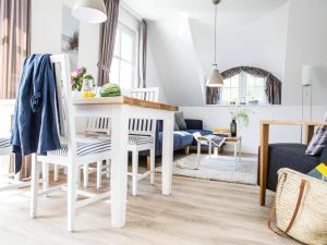 a living room with a white table and chairs at Apartment, Zingst in Zingst +61 photos