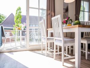 a room with a table and chairs on a balcony at Apartment, Zingst in Zingst