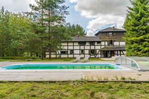 a house with a swimming pool in front of it at Imperial Apartments - Villa Koleczkowo in Koleczkowo