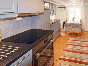 a kitchen with a black counter top in a room at 7 person holiday home in Skutvik in Skutvika
