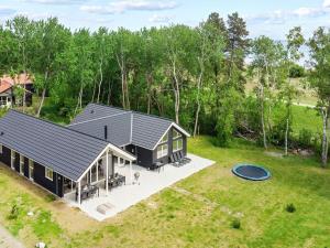an overhead view of a black house with a backyard at 18 person holiday home in Væggerløse in Marielyst