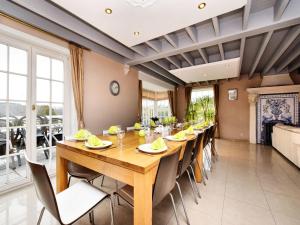 a dining room with a long table and chairs at Durbuy Luxe Villa with Pool in Petite Somme