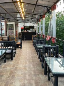 a restaurant with tables and chairs and a counter at Boutique Hotel Point in Tbilisi City