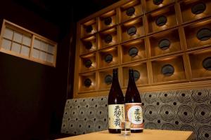 two bottles of wine sitting on top of a table at Hotel Matsunoi Shurin in Tokyo