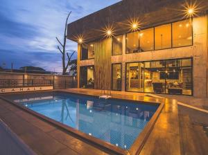 a large house with a swimming pool in front of it at The Canale Hat Yai in Songkhla