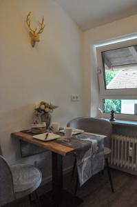 a dining room table with two chairs and a window at Apartment Schildenstein in Rottach-Egern