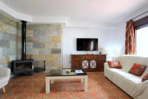 a living room with a couch and a fireplace at Casa Rocio 1 in Conil de la Frontera