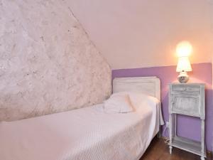 a bedroom with a white bed and a lamp on a night stand at Charming Gîte in France for a Private Getaway in Mézy-Moulins
