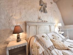 a bedroom with a bed and a table with a lamp at Charming Gîte in France for a Private Getaway in Mézy-Moulins