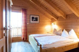 a bedroom with a bed in a wooden room at Holiday home in Stefan in the Lavanttal with balcony in Elsenbrunn