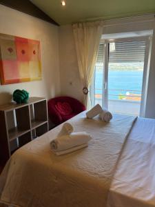 a bedroom with a bed with towels on it at Apartman Renata & Apartman Maja in Trogir