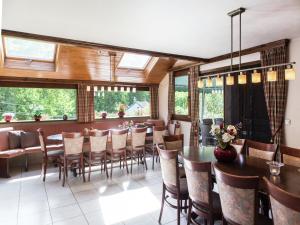 a dining room with a long table and chairs at Atmospheric holiday home in Durbuy with sauna in Septon