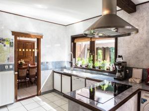 a kitchen with a sink and a stove at Atmospheric holiday home in Durbuy with sauna in Septon