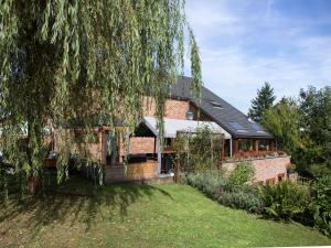 a brick house with a large tree in front of it at Atmospheric holiday home in Durbuy with sauna in Septon