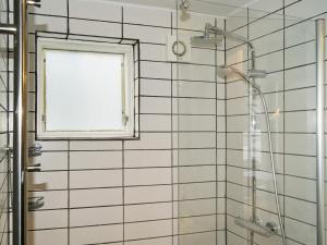 a bathroom with a shower with a window at Holiday home on a holiday park in Ebeltoft in Ebeltoft