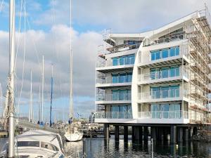a large white building with boats in a marina at 5 star holiday home in Wendtorf in Wendtorf +34 photos