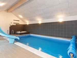 a swimming pool with a slide in a bathroom at 22 person holiday home in Jerup in Jerup