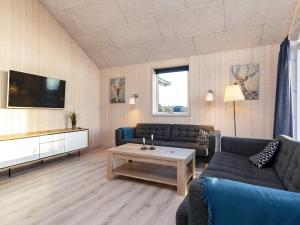 a living room with two couches and a coffee table at 22 person holiday home in Jerup in Jerup +83 photos