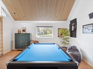a pool table in a living room with a ceiling at 5 star holiday home in Dronningmølle in Dronningmølle