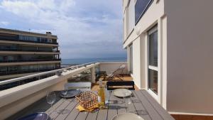 a balcony with a table and chairs on a building at Magnifique vue mer et terrasse Garage Clim WiFi - ROSSIconciergerie - Linge inclus in La Grande-Motte