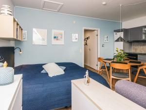a bedroom with a blue bed and a dining room at 2 person holiday home in Hejls in Hejls +28 photos