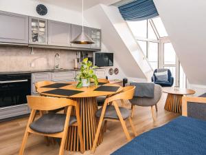 a kitchen and dining room with a table and chairs at 2 person holiday home in Hejls in Hejls