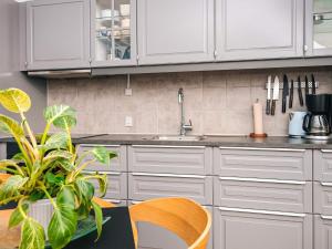 a kitchen with white cabinets and a sink at 2 person holiday home in Hejls in Hejls