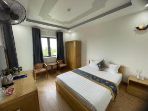 a hotel room with a bed and a desk and window at My Dream Hotel in Vung Tau